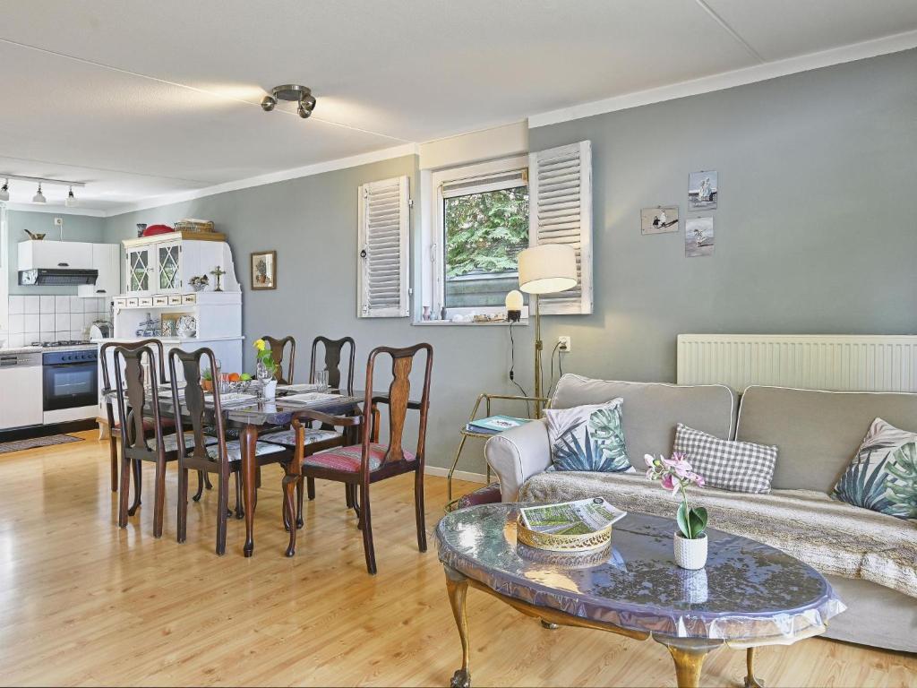 a living room with a couch and a table at Rose Garden in Stevensweert