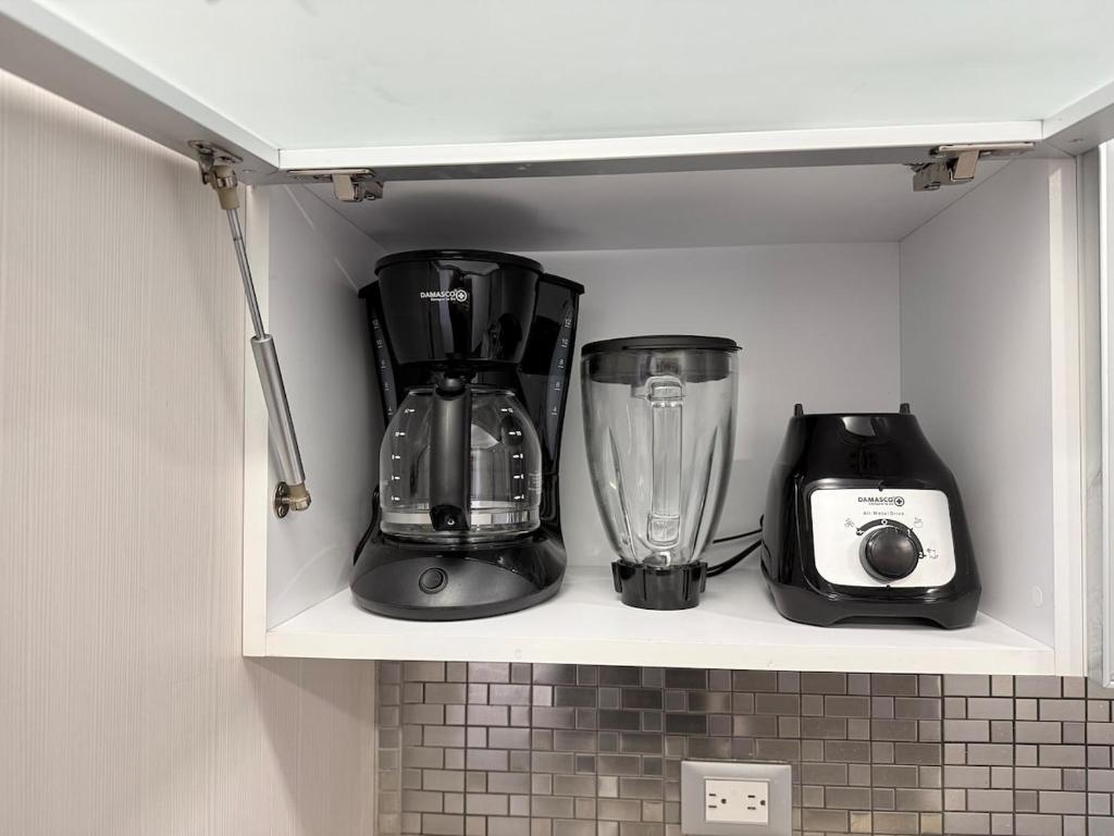 two blender and a toaster sitting on a shelf at Elegant & Luxurious Apartment in Central Chacao in Caracas