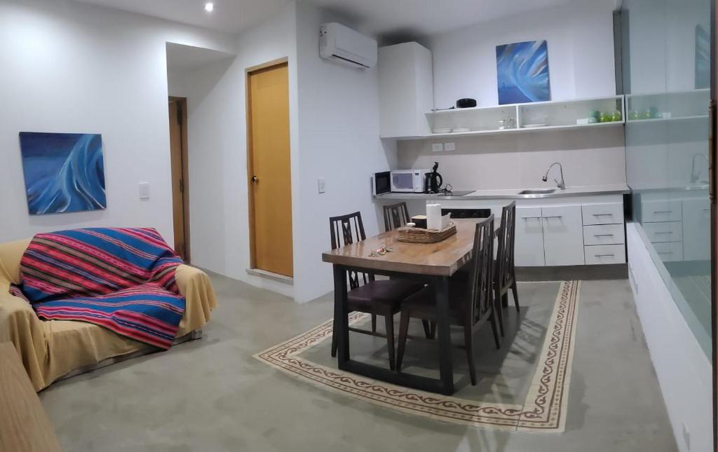 a kitchen with a table and a chair in a room at APARTAMENTOS FRERS in Martínez