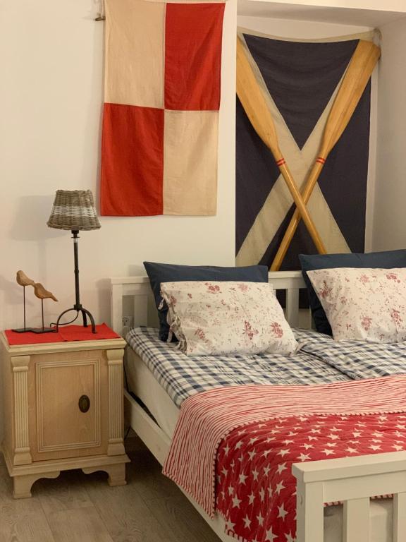 a bedroom with two beds and a painting on the wall at Apartamenty MARINE in Świnoujście