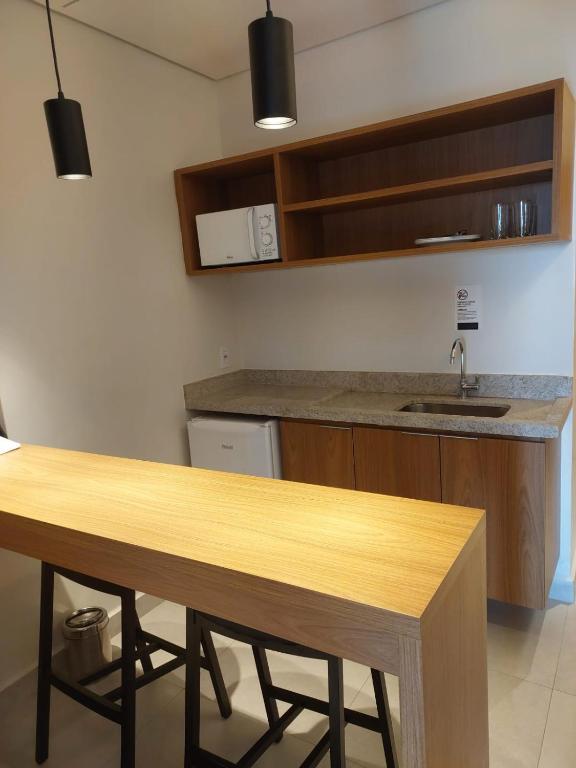 una cucina con un tavolo di legno e un lavello di Apt 01 quarto Resort Salinas Premium a Salinópolis