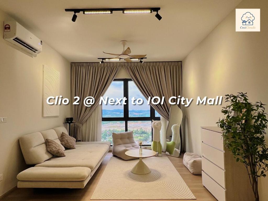 a living room with a couch and a table at Calm MUJI-Inspired Home - Stunning Sunset View - Steps To IOI City Mall - Your Best Urban Retreat in Putrajaya
