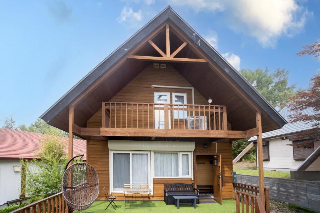 a small house with a gambrel roof at LAKE TOYA PREMIUM CABIN in Lake Toya