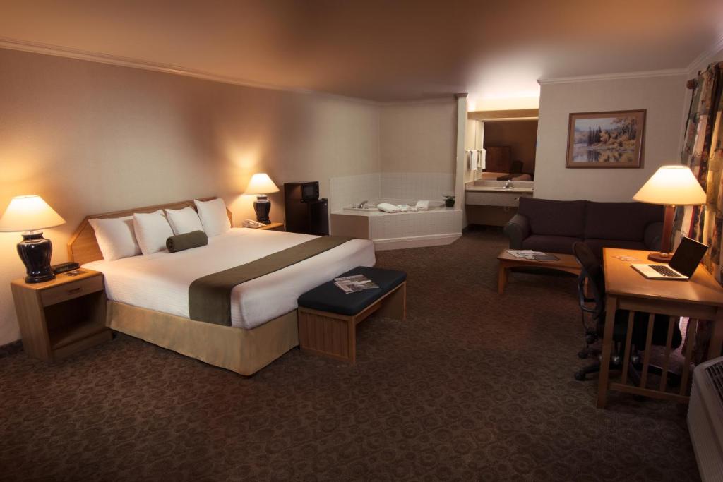 a hotel room with a bed and a couch at The Redwood Riverwalk, a boutique hotel in Fortuna