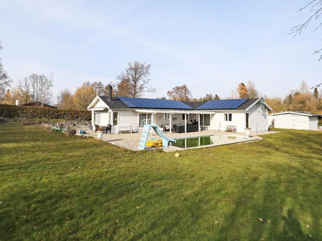 a house with a swimming pool and a yard at 10-Person Home in Rødvig Stevns in Lund