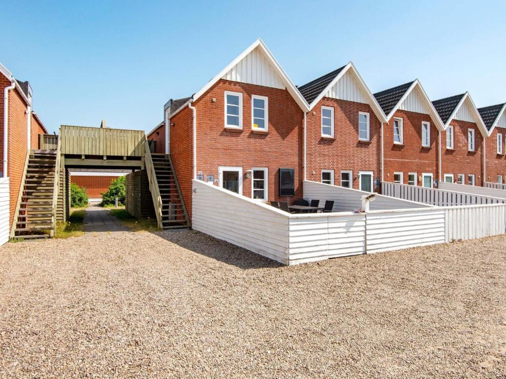 a row of brick houses with a tunnel in front at 5 person holiday home in Rømø-By Traum in Sønderby