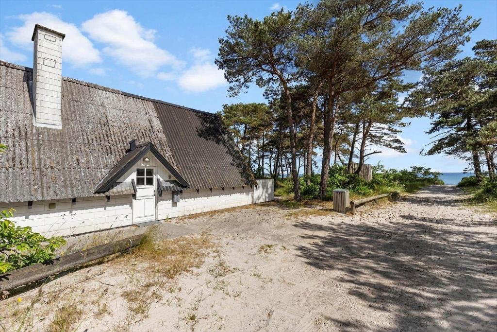 a house on the beach next to a building at 3646-Nexo-Frederiksvej-8 in Neksø