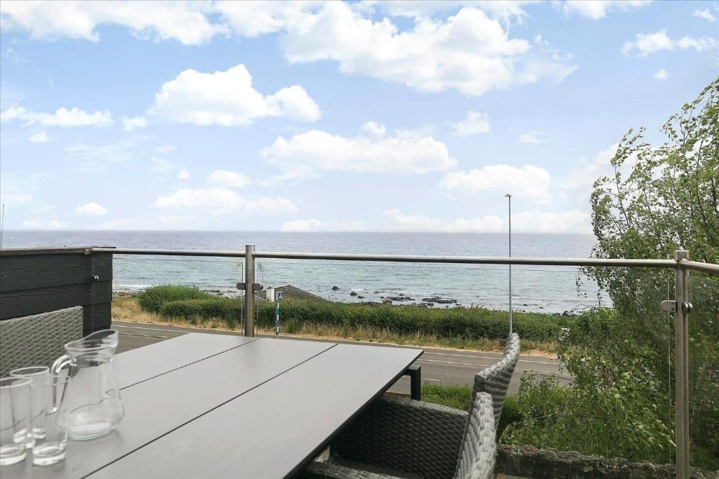 a white table with a view of the ocean at 6797-Allinge-Nordre-Strandvej-127 in Allinge
