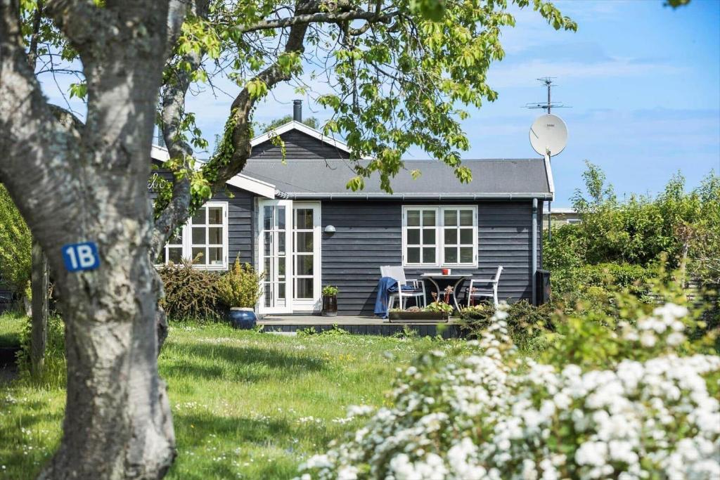 a blue house with a picnic table in front of it at 6667-Allinge-Solvej-1-B in Allinge