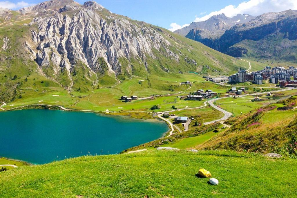 a view of a mountain with a town and a lake at Melide apartment in Melide