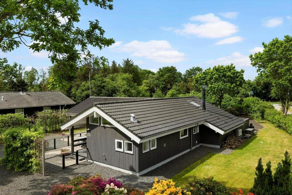 a small house with a gray roof at OH551-Hadsund-Ved-Fruerlund-35 in Hadsund
