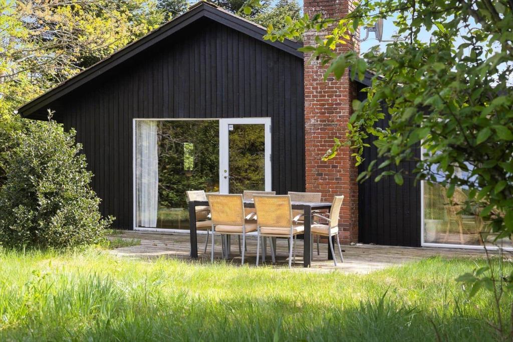a table and chairs in front of a building at LF14138-Spottrup-Heden-11 in Spottrup