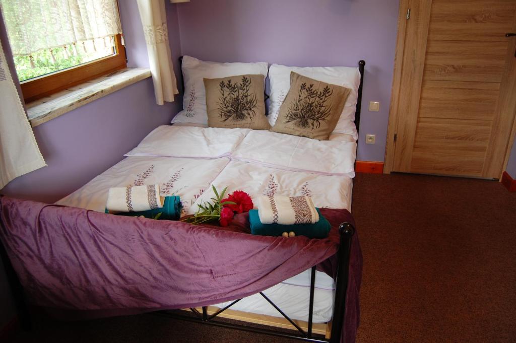 a small bed with pillows on it in a room at Pokoje Gościnne Pod Ciupagą in Bukowina Tatrzańska