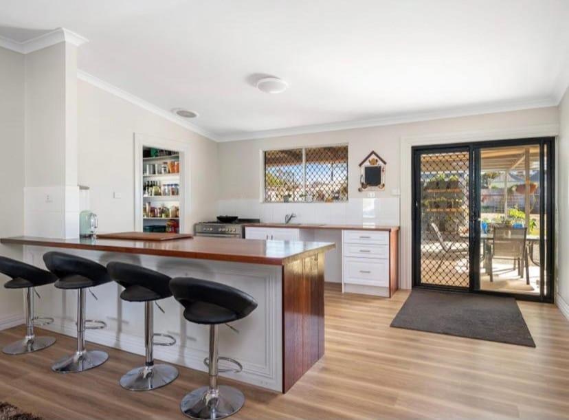 a kitchen with a counter and bar stools at 1915 cottage renovated and ready in Boulder