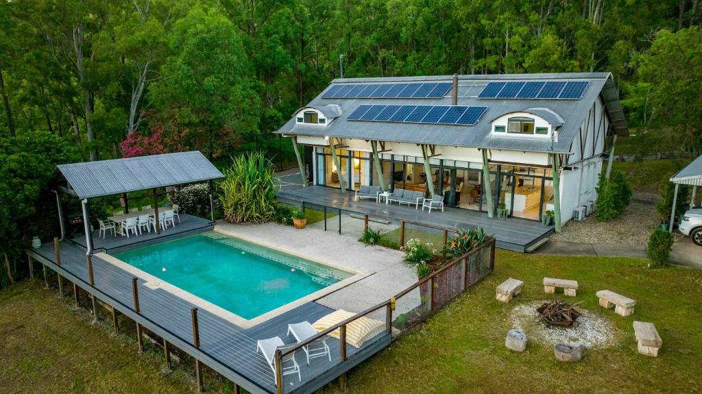 an aerial view of a house with a swimming pool at The Farm on Razorback Ridge in Montville