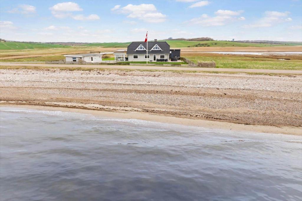 a house on the shore of a beach with water at LF332-Hurup-Helligsovej-32 in Hurup