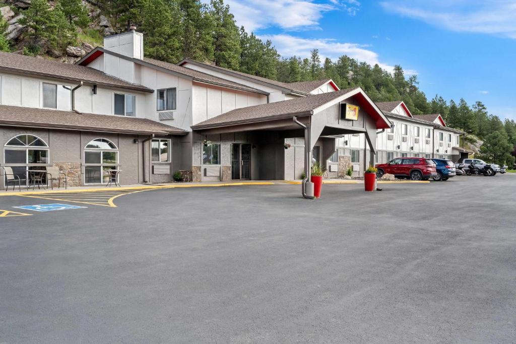 a large parking lot in front of a hotel at Super 8 by Wyndham Custer/Crazy Horse Area in Custer