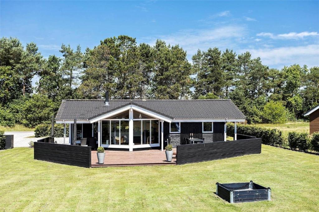 a house with a deck in a yard at OH287-Hadsund-Haslevgarde-Eng-1 in Hadsund