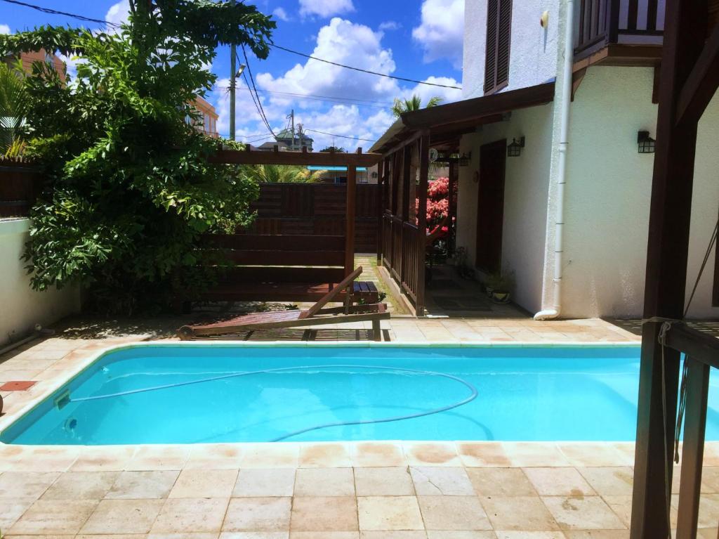 a swimming pool in the backyard of a house at Sannyasa Wellness and Spa in Trou aux Biches