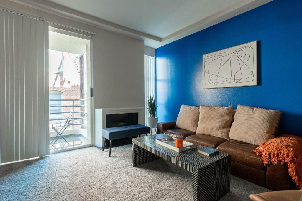 ein Wohnzimmer mit einem braunen Sofa und einer blauen Wand in der Unterkunft Marvelous 2BR 2BA Apartment in Los Angeles