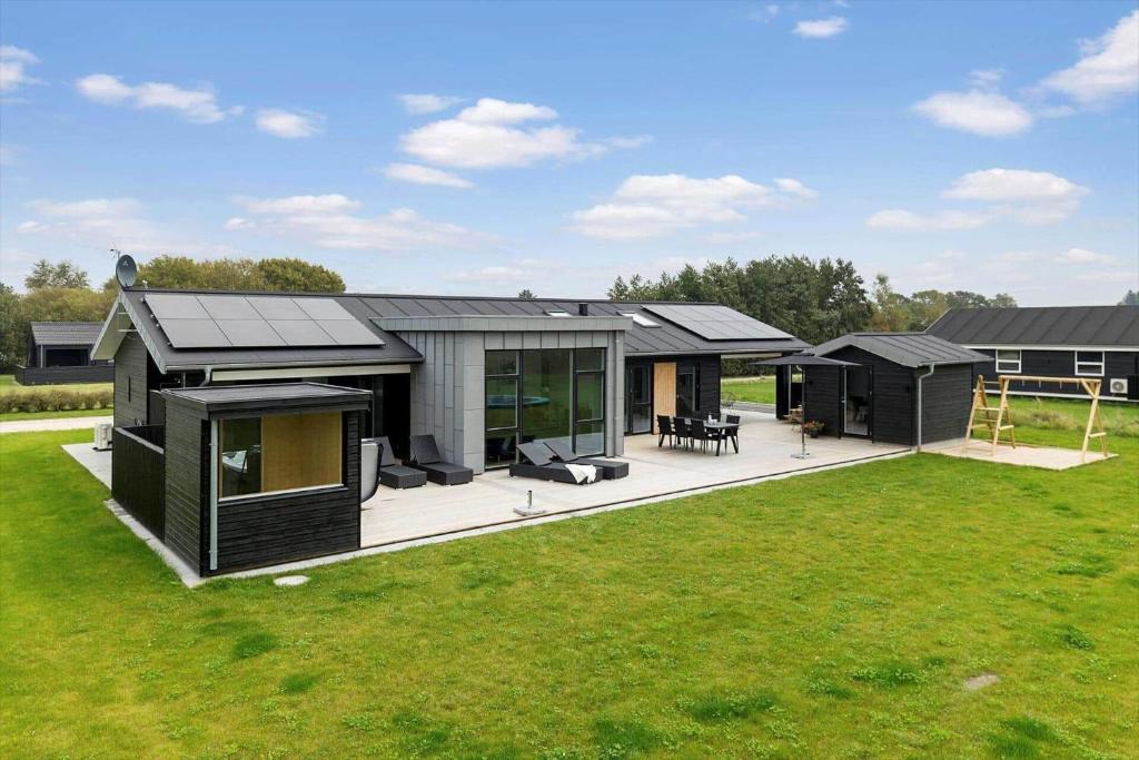 a modern black house with a large backyard at OH513-Hadsund-Haslevgarde-Eng-14 in Hadsund