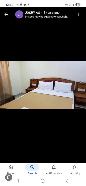 Ένα ή περισσότερα κρεβάτια σε δωμάτιο στο Dp Oberoi residency