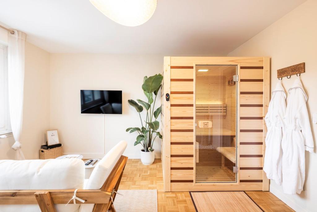 a bedroom with a large wooden closet at L'Escapade Secrète balnéo - sauna - love room in Arras