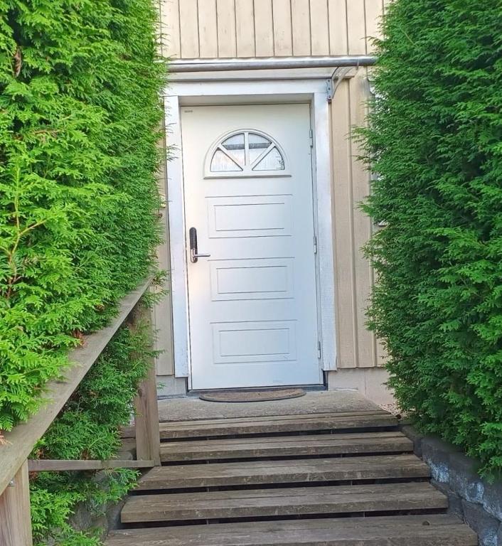 a white door on the side of a house at Comfortable apartment in Nyköping