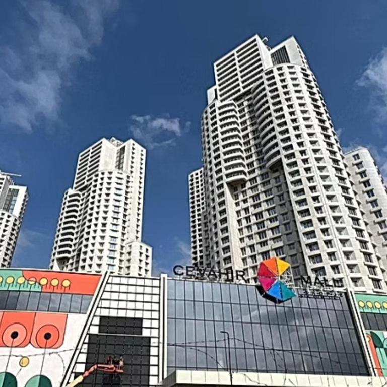 a colorful umbrella on top of a building with tall buildings at Bloom Apartments B in Skopje