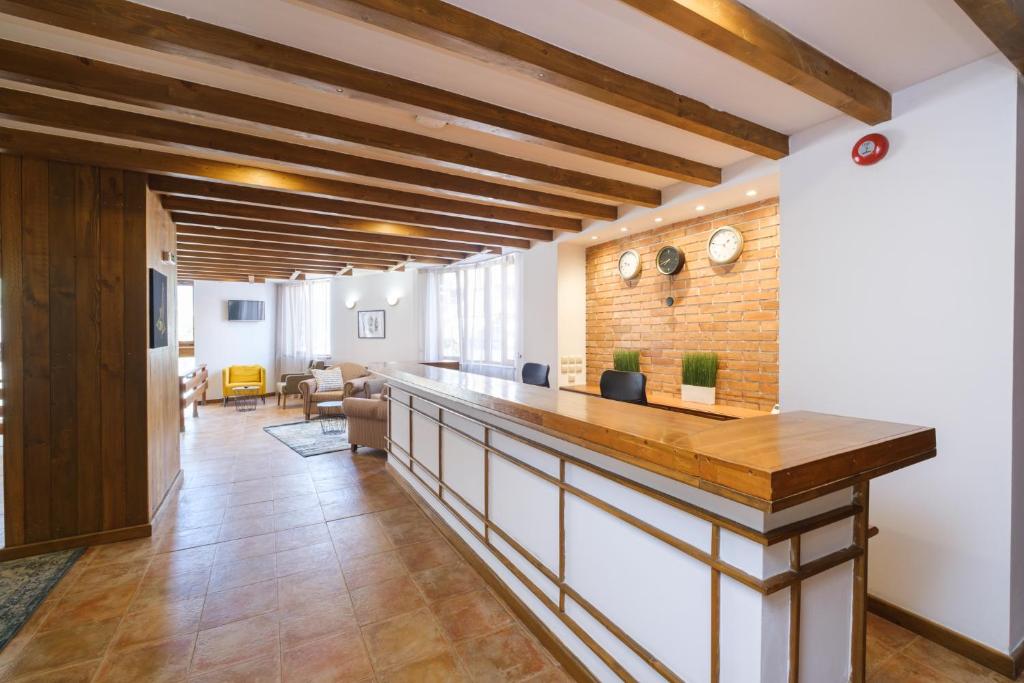 a kitchen with a counter and a brick wall at Hotel Razlog in Razlog