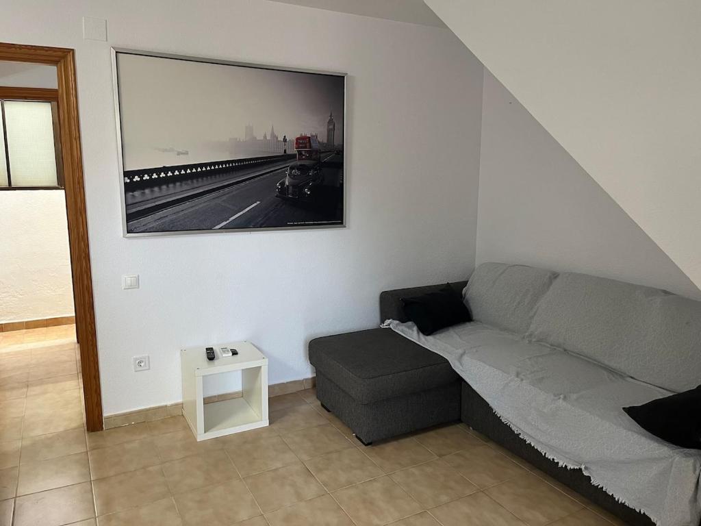un salon avec un canapé et un tableau au mur dans l'établissement San Juan Beach Bungalow - Muchavista, à San Juan de Alicante