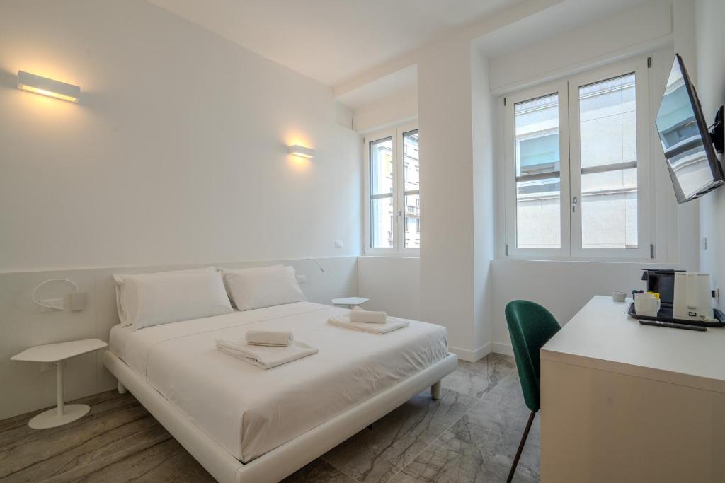 a white bedroom with a bed and a desk at Italianflat - Vandom 1 Suite Duomo Foresteria Lombarda in Milan