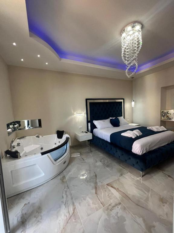a bedroom with a bed and a bathtub and a bed and a bathtub at La Romantique Rooms and Apartments TROPEA in Parghelia