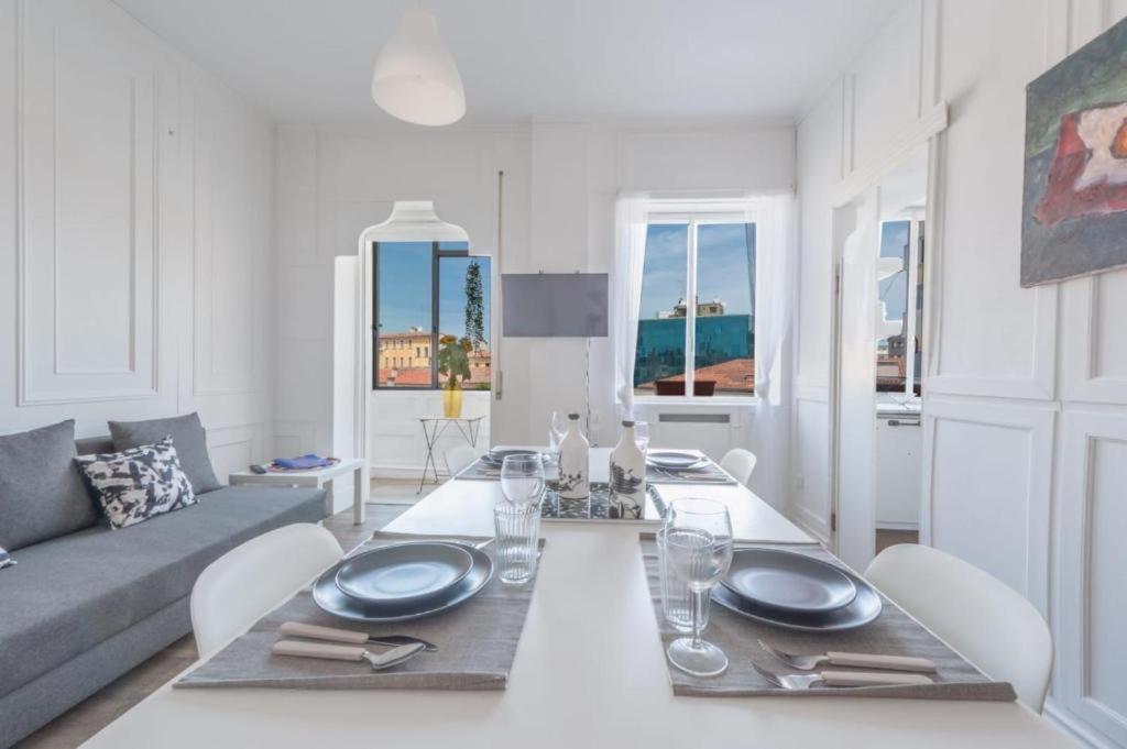 a white living room with a table and a couch at Mestre Attico Terrazza by Bricola Apartments in Venice