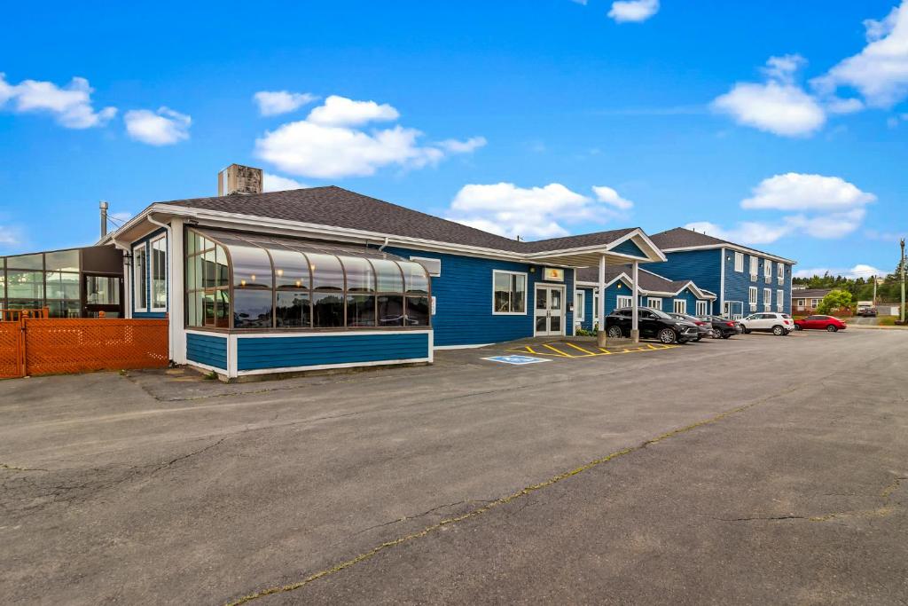 a blue building with a parking lot in front of it at Bayview Inn in Bay Roberts