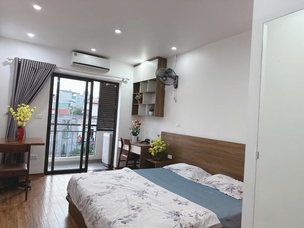 a bedroom with a bed and a large window at Sông Tranh 402MD in Hanoi