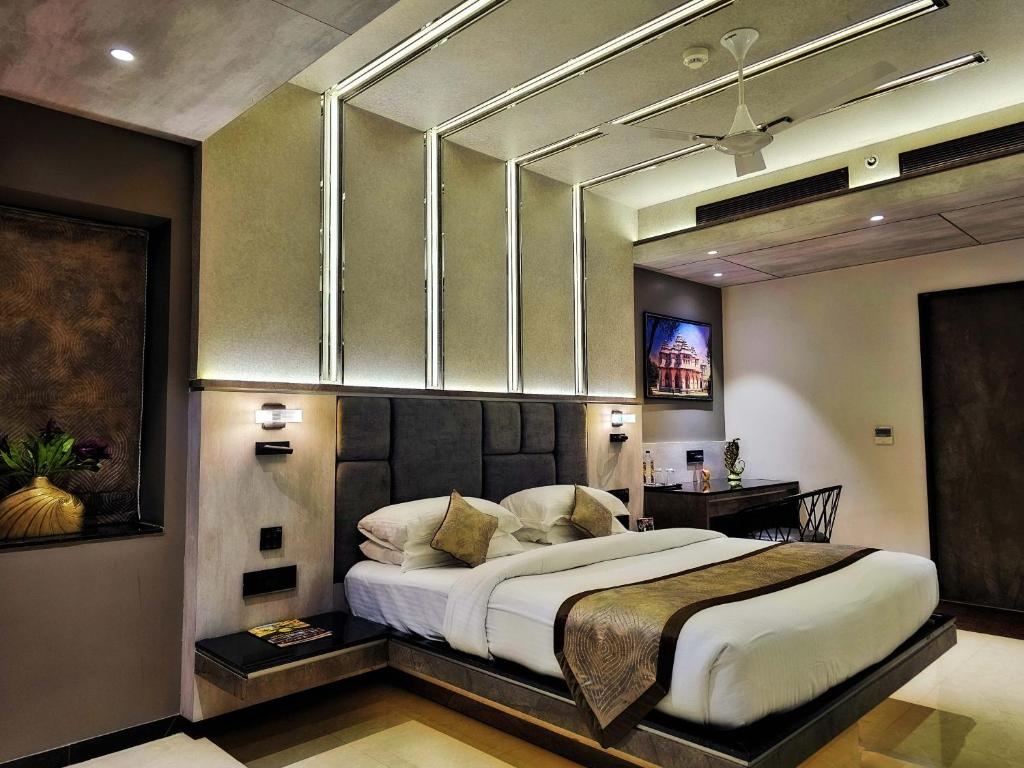 a bedroom with a large bed in a room at Malligi,Hampi in Hospet