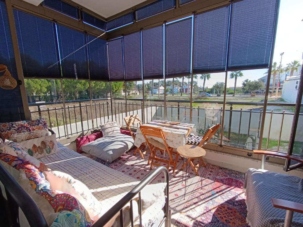 a room with a balcony with a table and chairs at side side in Side