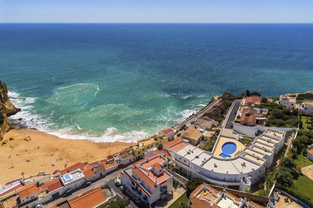 an aerial view of a beach with houses and the ocean at Casa Carvoeiro Bay J in Carvoeiro