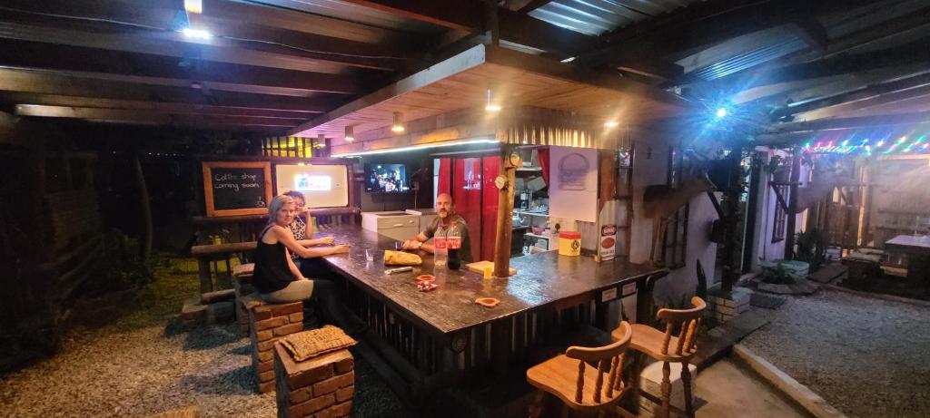 a woman sitting at a bar in a kitchen at Aberdeen Self Catering in Aberdeen