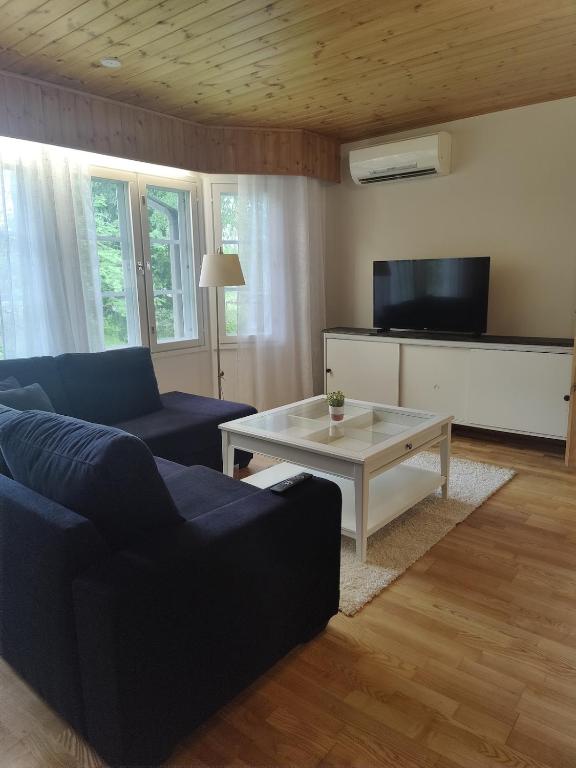 a living room with a couch and a coffee table at Kodikas talo lammen rannalla in Raahe
