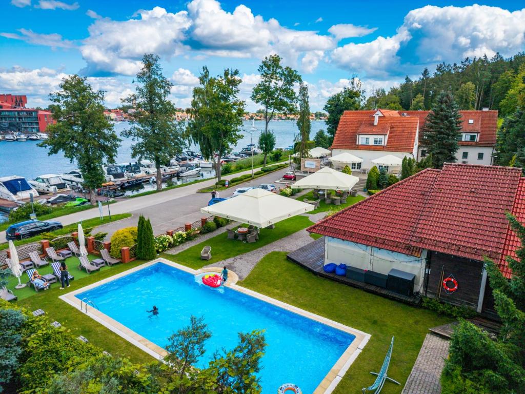 an aerial view of a house and a swimming pool at Amax Boutique Hotel in Mikołajki