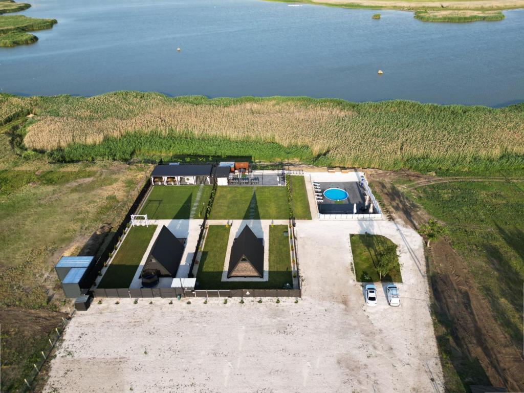 an aerial view of a house on a hill next to the water at Dravis Event Park 