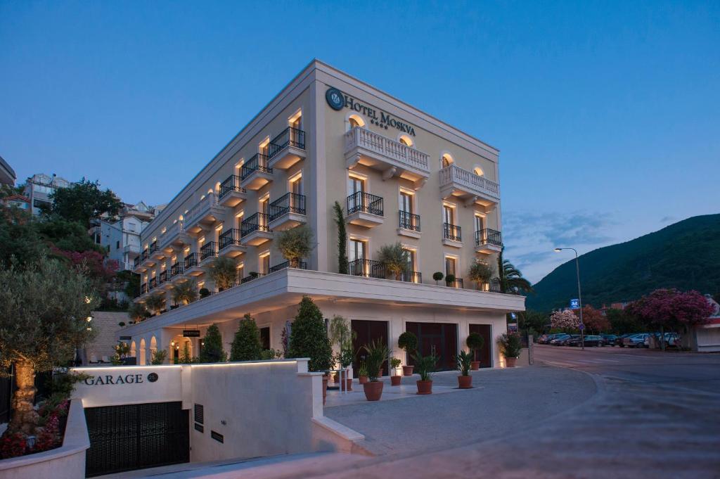 a large white building on a city street at Hotel Moskva in Budva