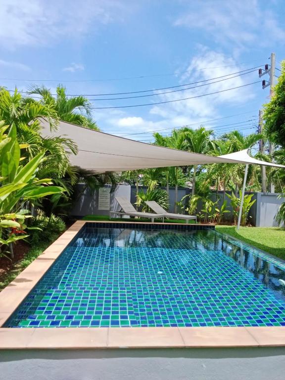 a swimming pool in a villa with a canopy at Tranquility in Bangrak Beach