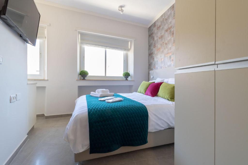 a bedroom with a bed and a tv in it at DEM Hotel in Jerusalem