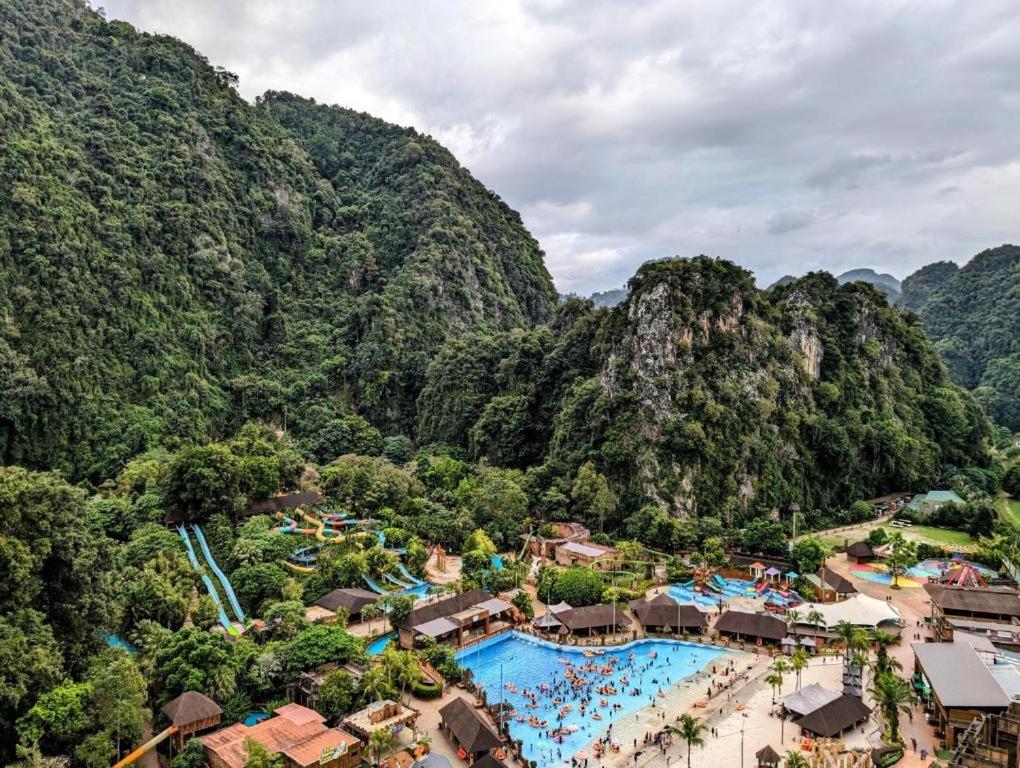 an aerial view of a water park with mountains at Nadis Guesthouse in Ipoh