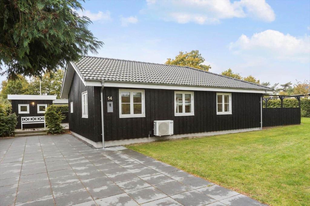 a black and white house with a yard at OH532-Hadsund-Avaenget-14 in Hadsund