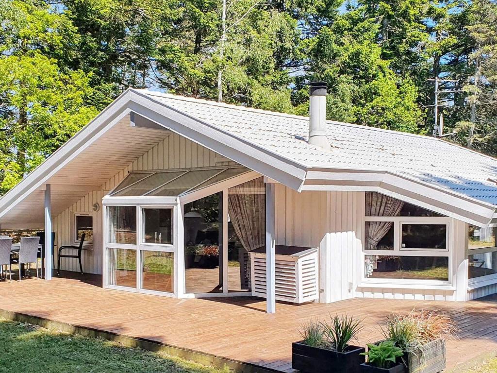 a small house with a porch and a deck at 6 person holiday home in Saltum in Saltum