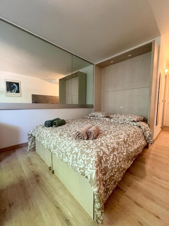 a bedroom with a large bed with a large mirror at Le Phoenica - Former Hotel - Parking in Carquefou